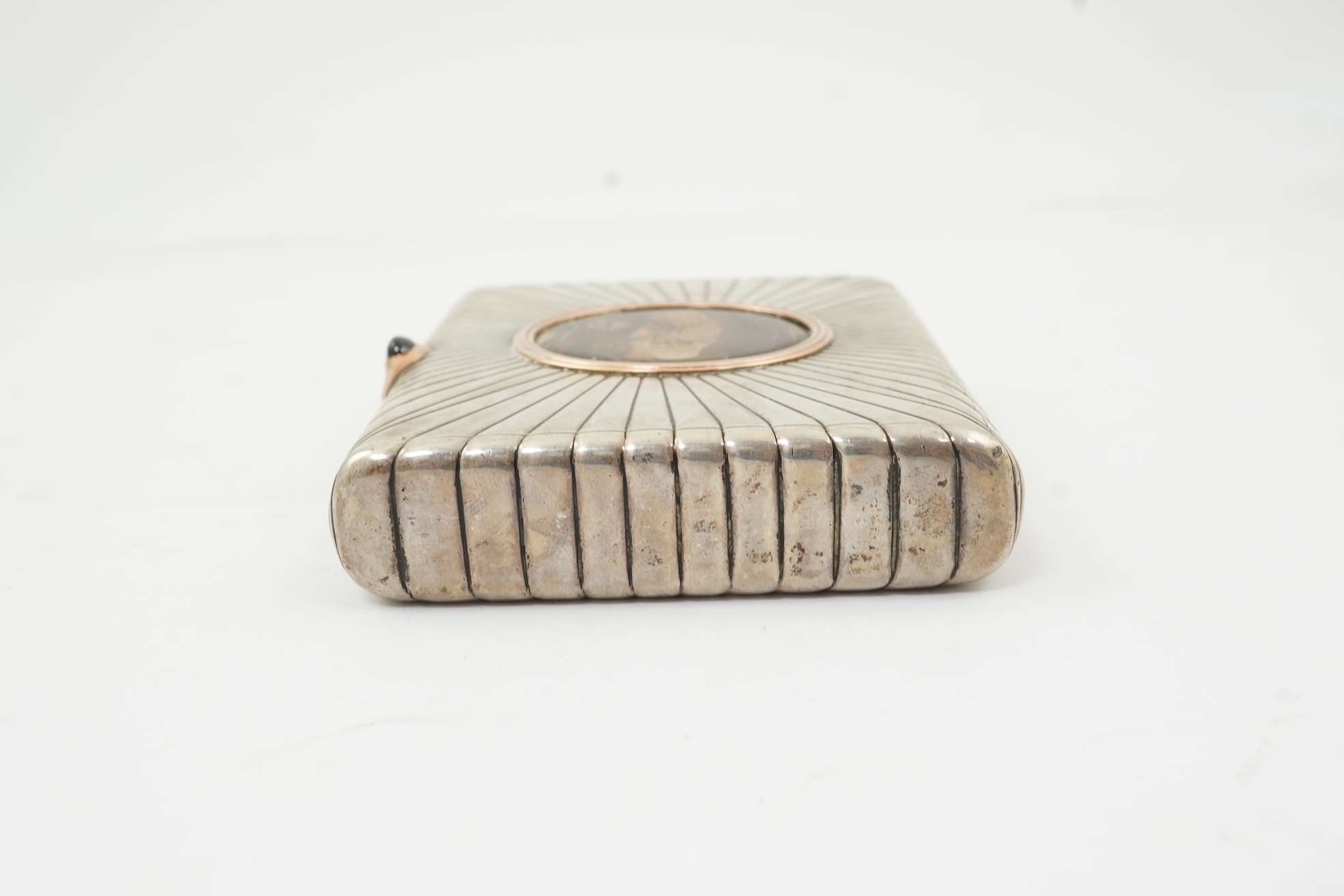 An early 20th century Russian 84 zolotnik silver cigarette case, with cappuccino agate inset cover, of ribbed rectangular form